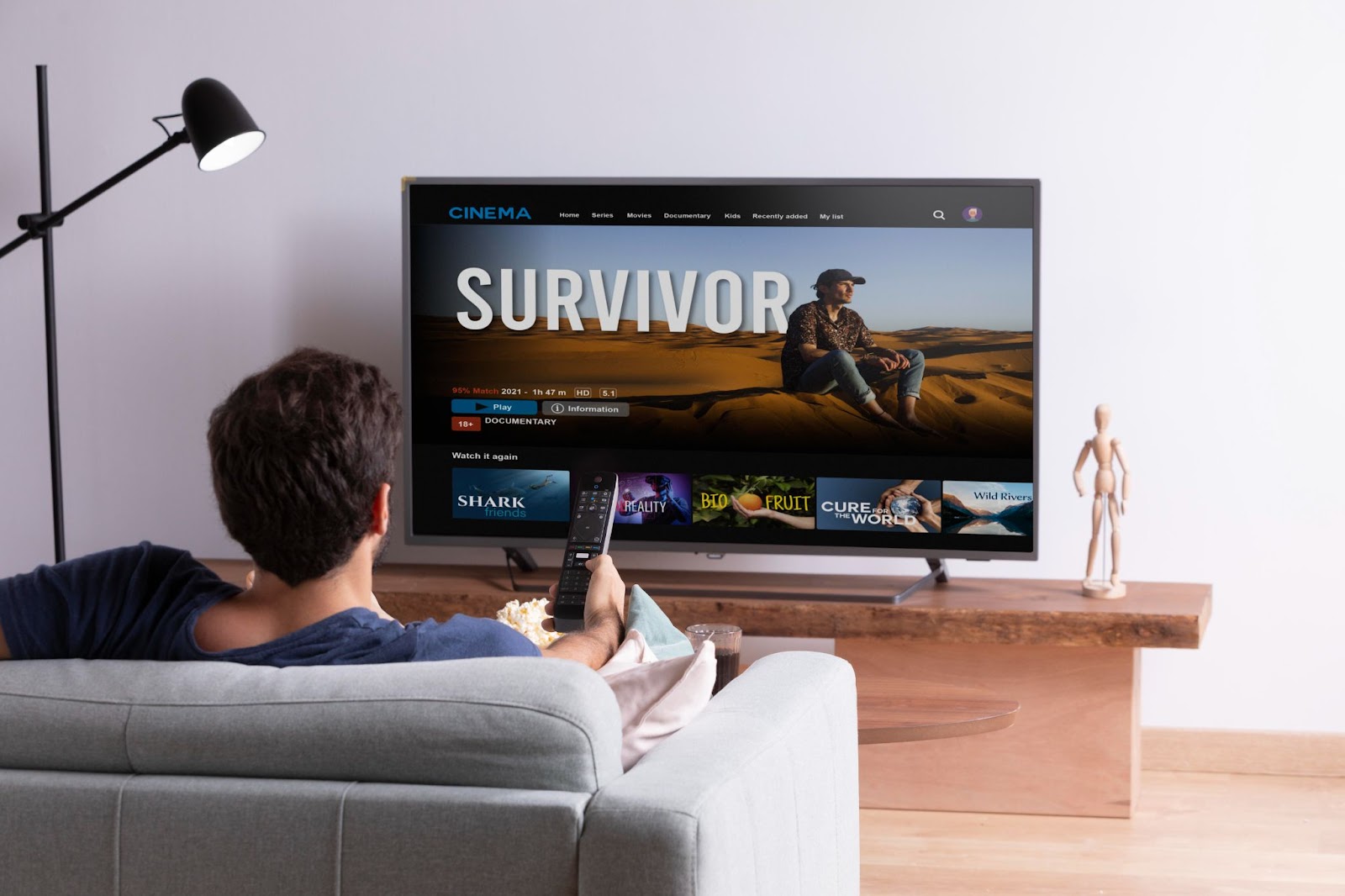Man watching TV show on sofa.